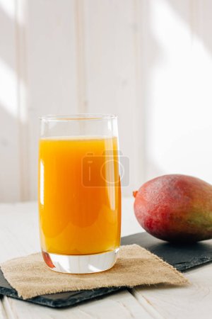 Photo for "Mango juice in a glass, fresh fruit drink" - Royalty Free Image