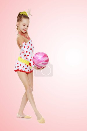 Photo for "Gymnast does exercises with a ball" - Royalty Free Image