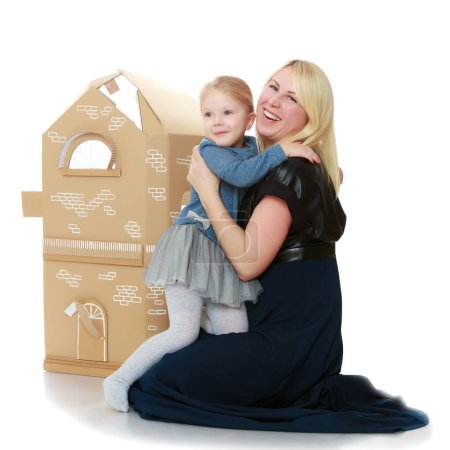 Photo for "Daughter and her mom play around the house out of cardboard." - Royalty Free Image