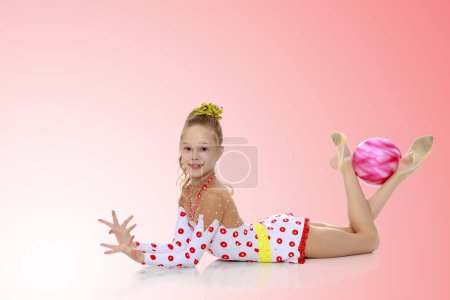 Photo for "Gymnast does exercises with a ball" - Royalty Free Image