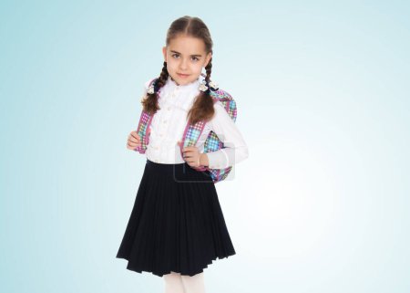 Photo for Beautiful schoolgirl with a backpack behind her shoulders. - Royalty Free Image