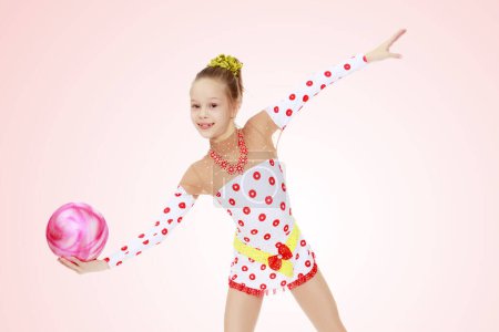 Photo for Gymnast does exercises with a ball - Royalty Free Image