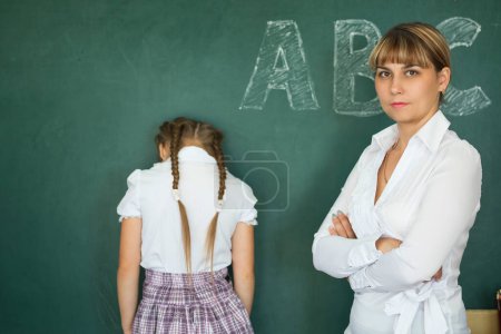 Photo for Teacher has punished the schoolgirl for the wrong example - Royalty Free Image