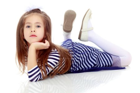 Photo for Little girl lying on the floor. - Royalty Free Image