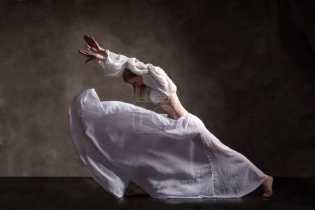 Téléchargez les photos : Jeune belle danseuse posant sur fond gris - en image libre de droit