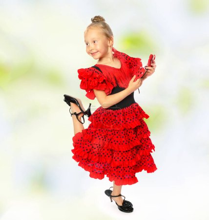 Photo for Little girl in the flamenco costume dancing in studio - Royalty Free Image