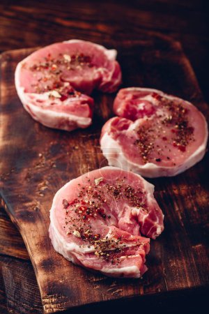 Photo for "Raw pork loin steaks with different spices" - Royalty Free Image