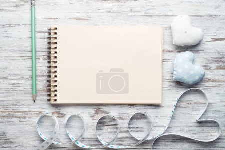 Photo for Open sketchbook with pen on vintage wooden table - Royalty Free Image