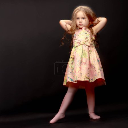 Photo for "Little girl on a black background" - Royalty Free Image