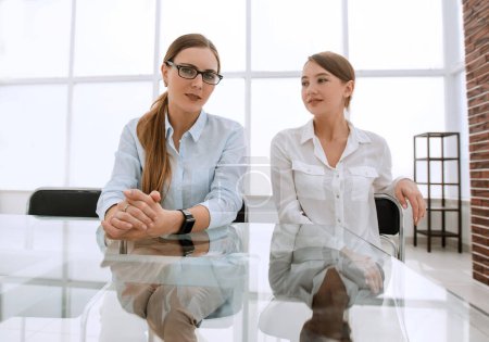 Photo for Two business women sitting at a table in the conference room - Royalty Free Image