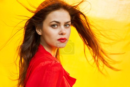 Photo for Woman in red dress posing yellow fabric nature - Royalty Free Image