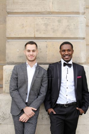 Photo for Afro american and caucasian gays standing near building. - Royalty Free Image