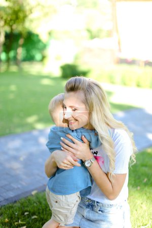 Photo for "Young blonde mother hugging little son." - Royalty Free Image