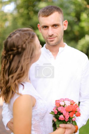 Photo for "Happy handsome european groom with caucasian bride." - Royalty Free Image