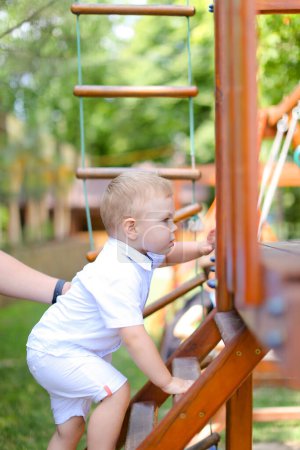 Téléchargez les photos : Little boy playing on children playground. - en image libre de droit