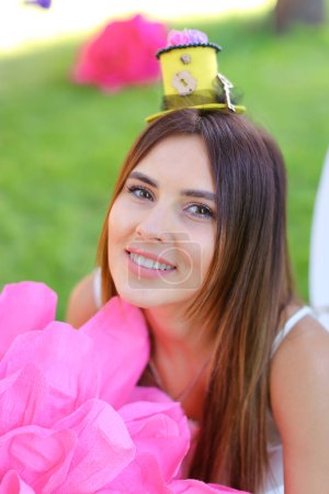 Téléchargez les photos : Portrait of young beautiful girl with big pink flower. - en image libre de droit