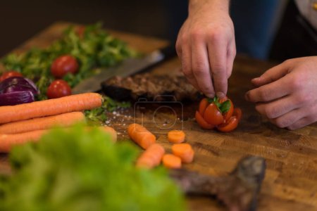 Photo for Close up view of chef hands preparing beef steak - Royalty Free Image