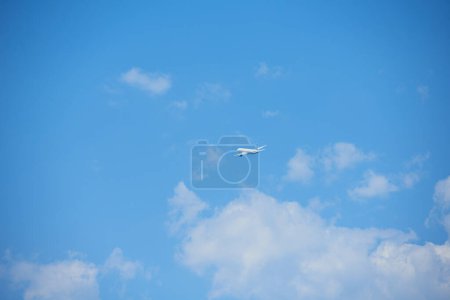 Photo for Clear blue sky and flying commercial airplane. aviation and aircraft trip concept - Royalty Free Image