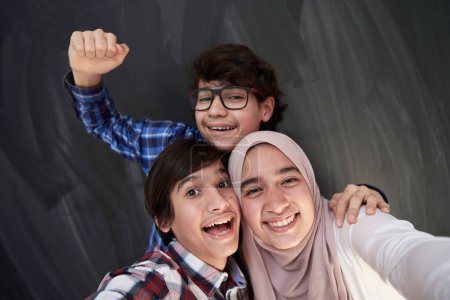 Photo for Group of arab teens taking selfie photo on smart phone - Royalty Free Image