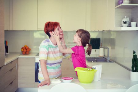 Photo for Mother and daughter playing and preparing dough in the kitchen. - Royalty Free Image