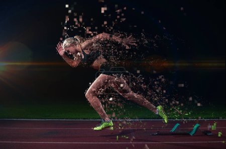 Photo for Young woman sprinter leaving starting blocks - Royalty Free Image