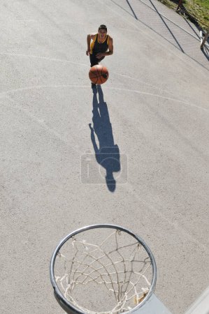 Photo for Man playing street basketball - Royalty Free Image