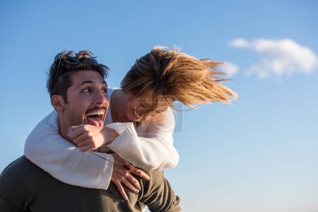 Photo for Couple having fun at beach on a sunny autumn day - Royalty Free Image