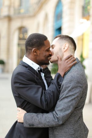 Afro american gay kissing caucasian man