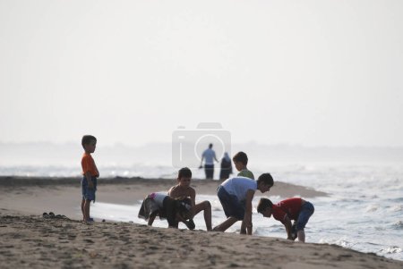 Photo for Children playing on sandy beach - Royalty Free Image