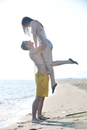 Photo for Happy young couple have romantic time on beach - Royalty Free Image