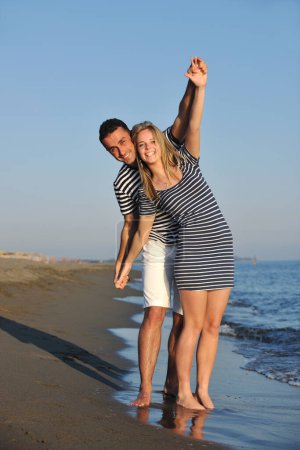 Photo for Happy young couple have romantic time on beach - Royalty Free Image