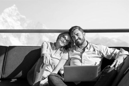 Photo for "couple relaxing at  home using laptop computers" - Royalty Free Image