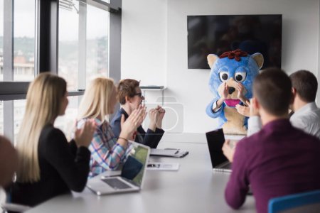 Photo for Boss dressed as bear having fun with business people in trendy office - Royalty Free Image