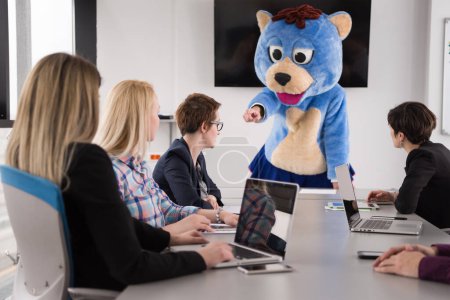 Photo for Boss dressed as bear having fun with business people in trendy office - Royalty Free Image