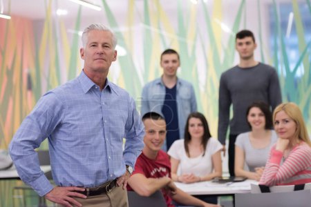 Photo for Portrait of  teacher with students group in background - Royalty Free Image