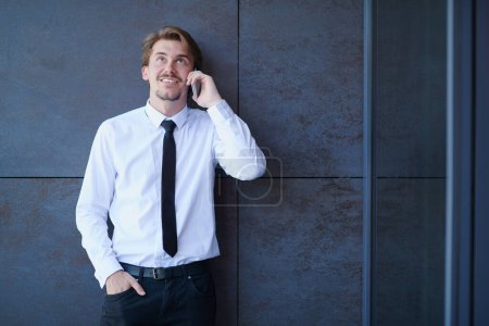 Photo for Startup businessman in a white shirt with a tie using mobile phone - Royalty Free Image