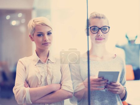 Foto de Pretty Businesswomen utilizando tableta en edificio de oficinas durante la conferencia - Imagen libre de derechos
