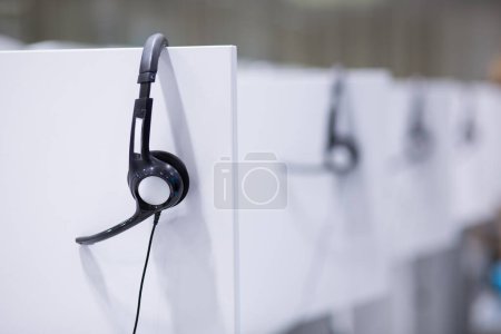 Photo for Headphones in empty call center office - Royalty Free Image