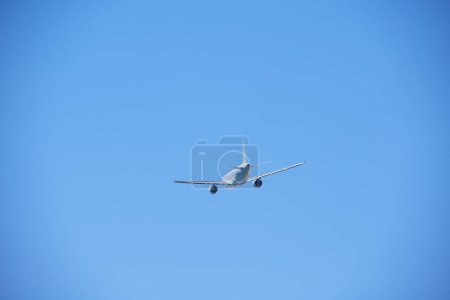 Photo for Clear blue sky and flying commercial airplane. aviation and aircraft trip concept - Royalty Free Image