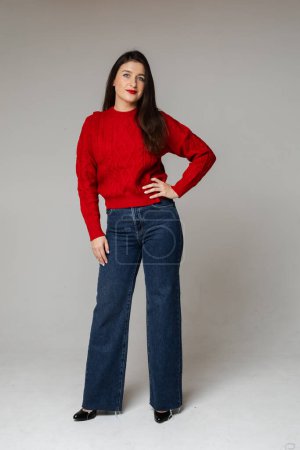 Photo for Stylish girl in red sweater and jeans. - Royalty Free Image