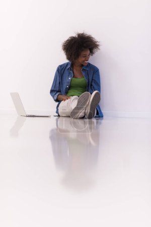 Photo for "african american woman sitting on floor with laptop" - Royalty Free Image