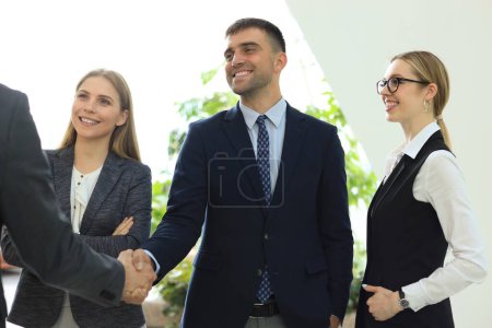 Photo for "Business people shaking hands, finishing up a meeting." - Royalty Free Image