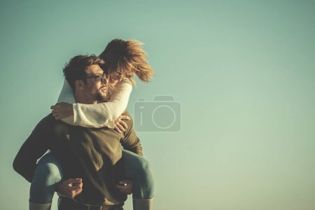 Photo for Couple having fun at beach during autumn - Royalty Free Image
