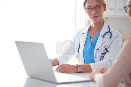 Photo for Doctor and patient couple are discussing something - Royalty Free Image