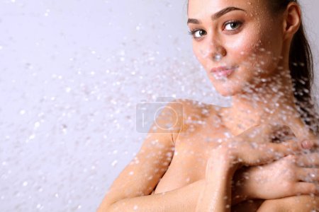 Photo for Young beautiful woman under shower in bathroom. - Royalty Free Image