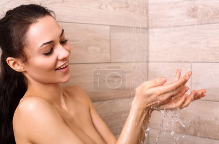 Photo for Young beautyful woman under shower in bathroom. - Royalty Free Image