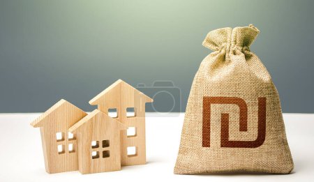 Photo for Israeli shekel money bag and residential buildings. City municipal budget. Mortgage loan. Property tax. Investment in real estate. Costs of service and maintaining. Purchase of housing. - Royalty Free Image