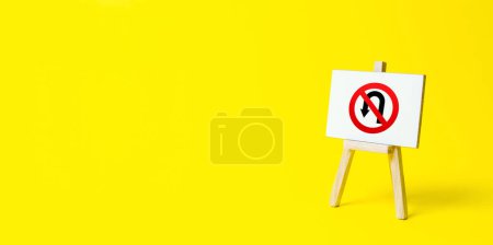Photo for Easel with no turning back traffic sign on a yellow background. Assertiveness and striving, moving forward without retreating. Go to the goal, don't stop. Finish things. There is no way back. - Royalty Free Image
