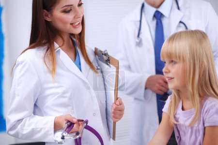 Photo for Female doctor examining child with stethoscope at surgery - Royalty Free Image