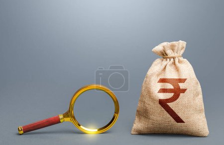 Photo for Indian rupee money bag and magnifying glass. Find high-paying job. Most favorable conditions for deposits, loans. Origin of capital and legality of funds. Search for financing. Financial audit. - Royalty Free Image